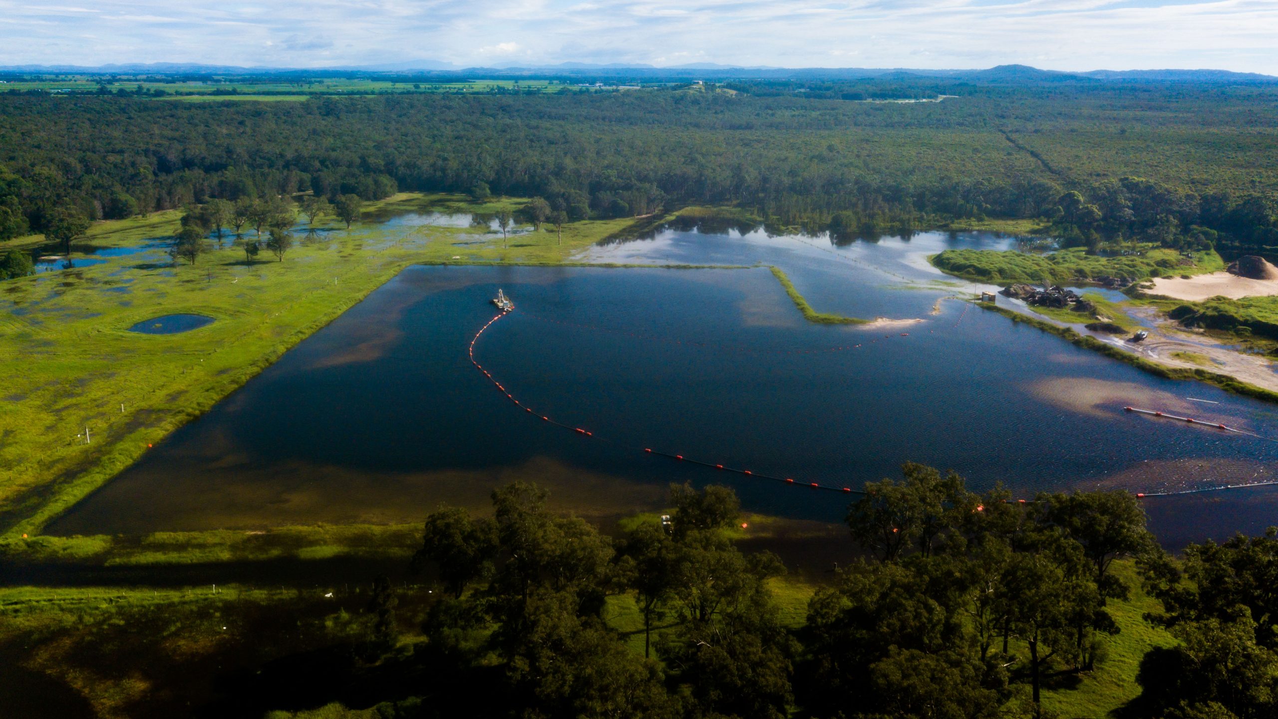 Aerial view of a sand dredge operating on a quarry pond